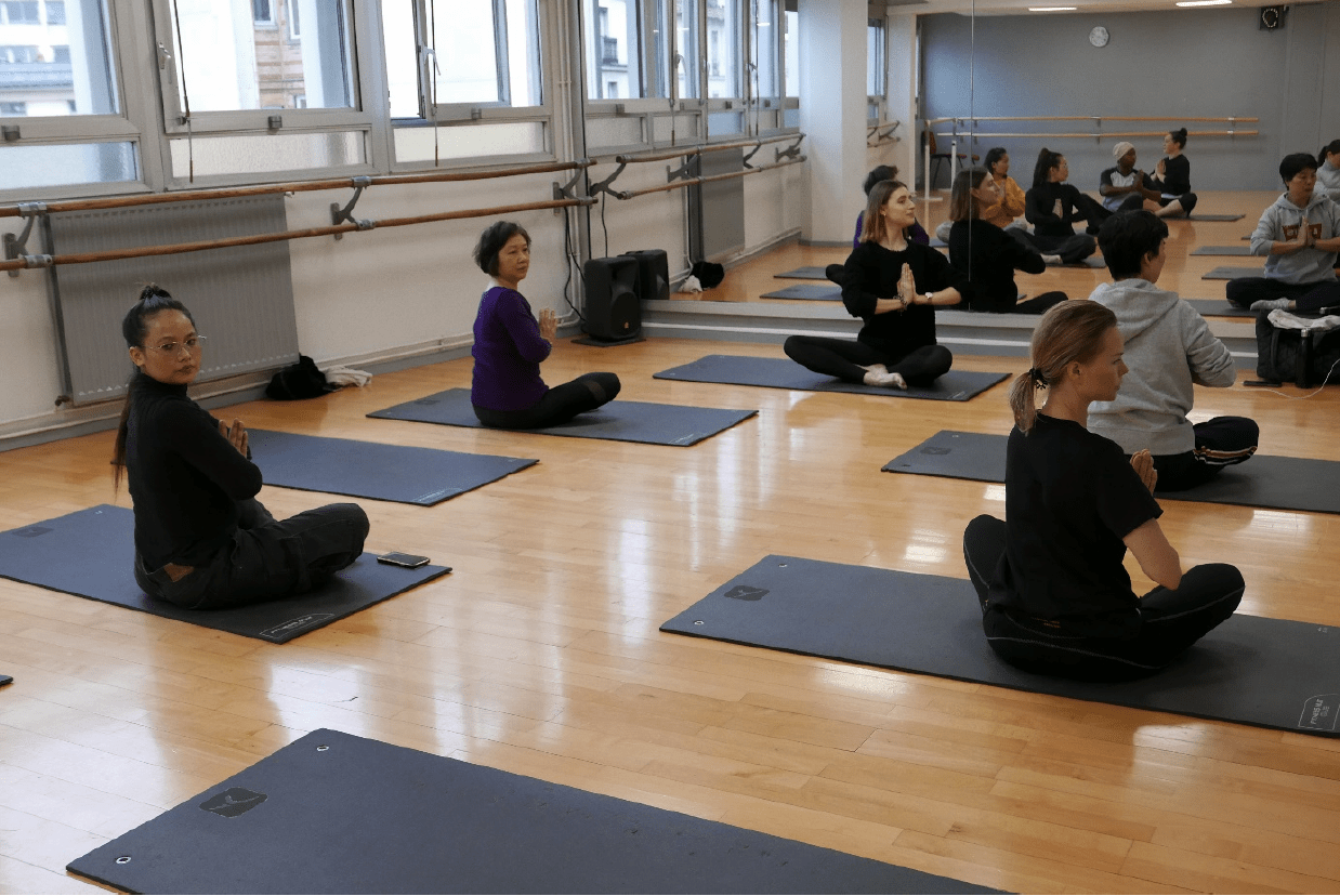 sport_sante_femmes-2 Groupe de femmes assises au sol en lotus pendant un cours de gym douce dans le cadre de l'activité Sport santé bien être pour les jeunes filles et jeunes femme