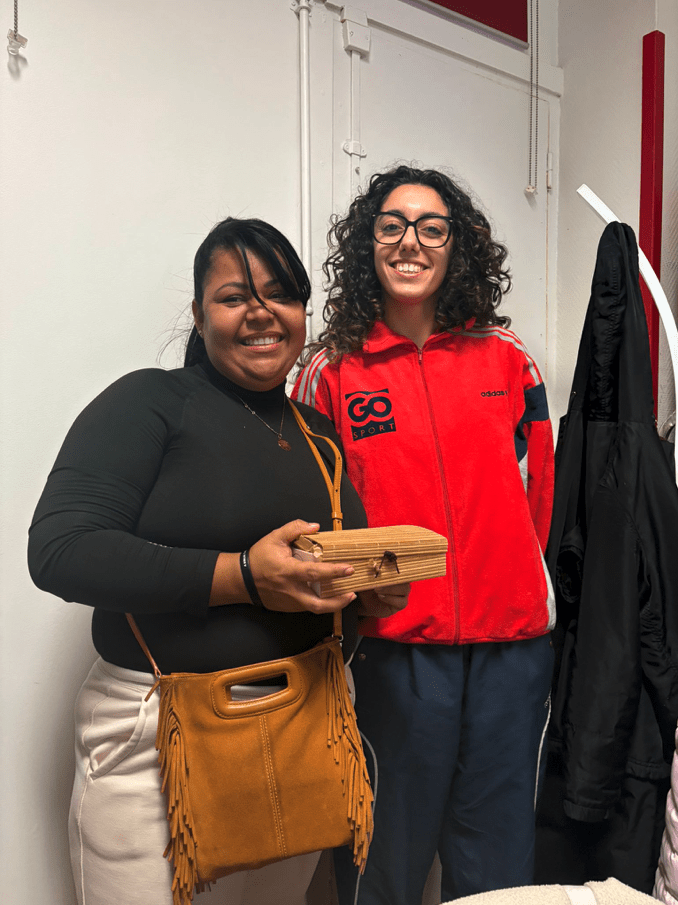 2 élèves souriants de l'atelier de conversation en français de l'association Axes Pluriels qui s'échangent des cadeaux de Noël pour décembre 2025